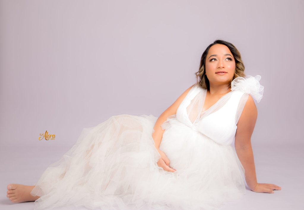 Pregnant mother posing during elegant maternity photoshoot in Cranbourne North photography studio by Kat Alora Photography