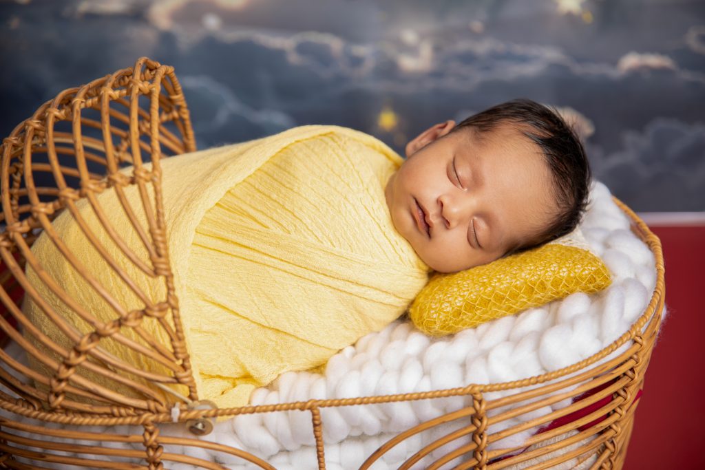 Melbourne at home newborn photography session with parents cuddling newborn baby