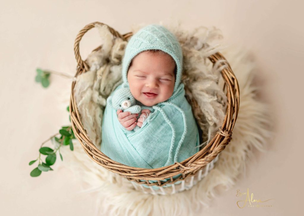 At home newborn photography Melbourne by Kat Alora Photography featuring parents cuddling their newborn baby in a natural lifestyle session