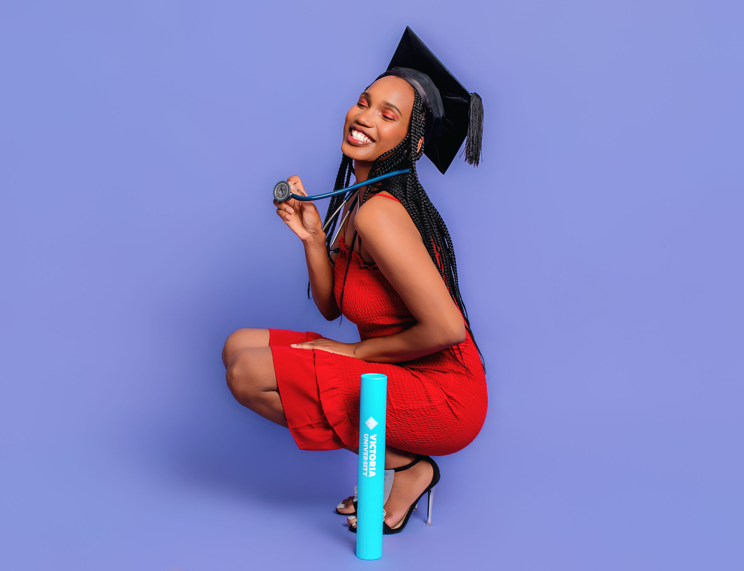 Fashion-inspired graduation portrait session with graduate wearing black gown and cap