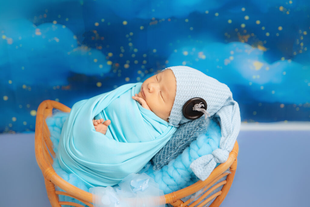 Affordable newborn photography Melbourne with wrapped baby posing in studio setup