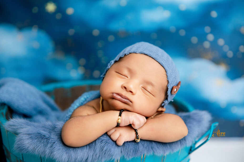 Newborn baby in basket prop during styled photoshoot