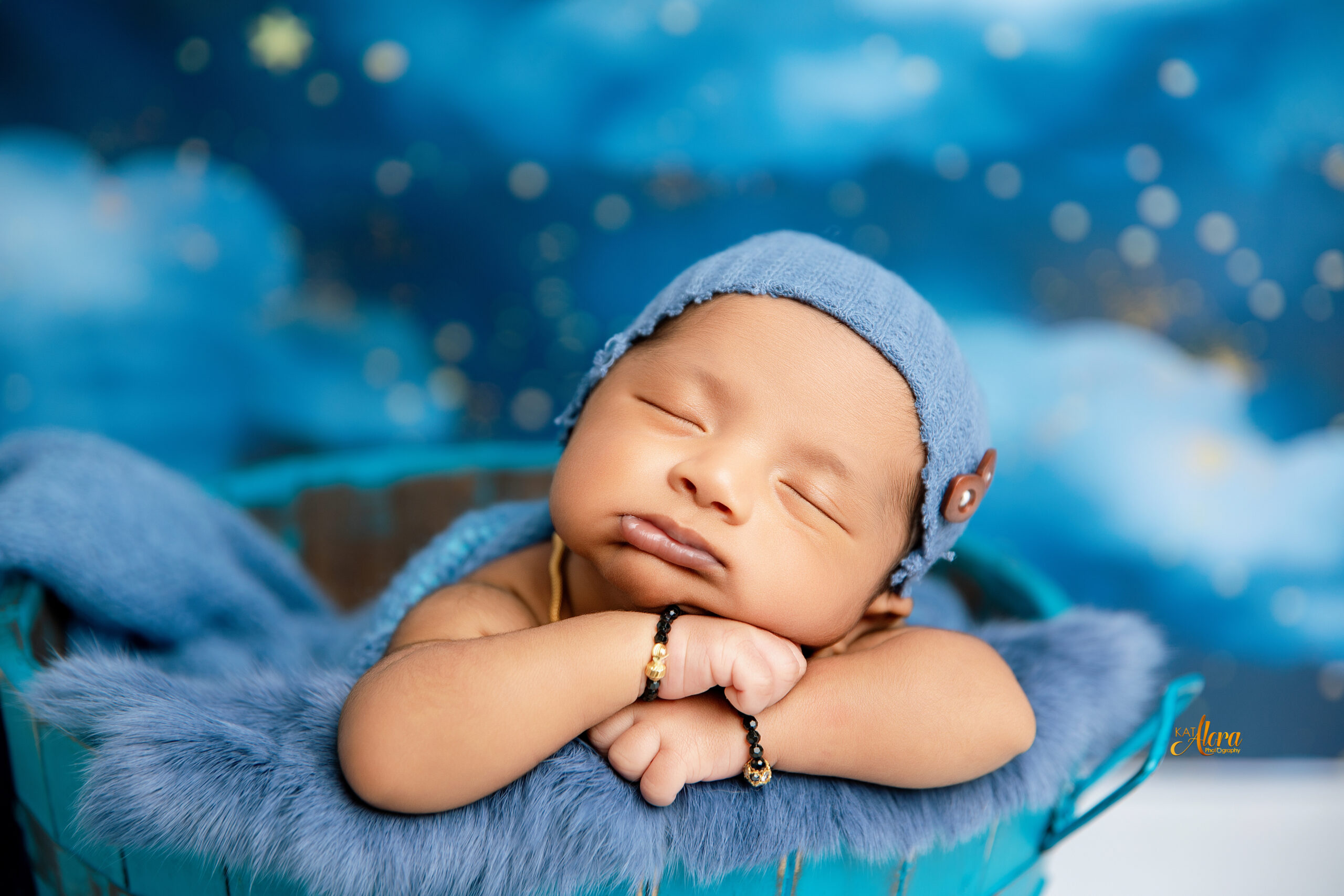 Newborn baby in basket prop during styled photoshoot