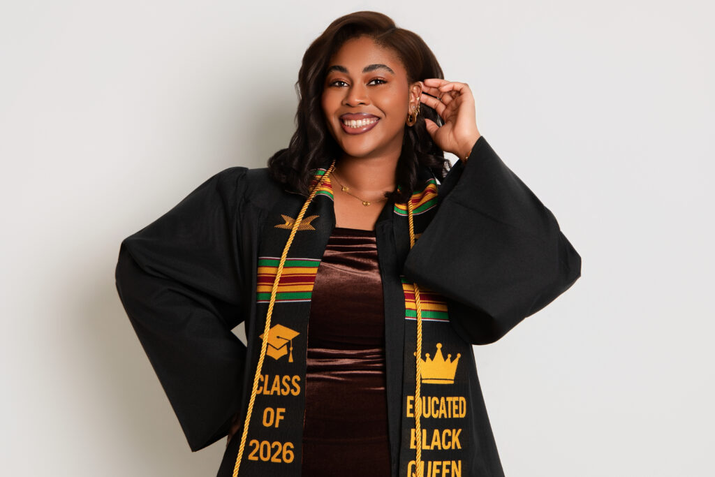 Female graduate smiling in graduation gown during luxury graduation photoshoot Melbourne